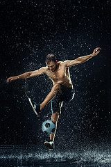 Image showing Water drops around football player