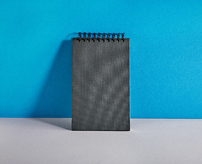 Image showing black notebook on colorful background