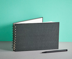 Image showing black notebook and pen