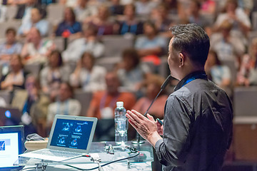 Image showing Public speaker giving talk at Business Event.