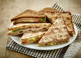 Image showing plate of various triangle sandwiches