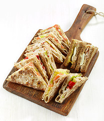 Image showing various triangle sandwiches on wooden board