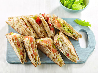 Image showing various sandwiches on wooden cutting board