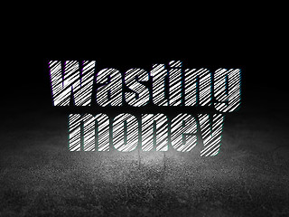 Image showing Money concept: Wasting Money in grunge dark room
