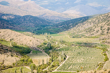 Image showing Beautiful valley with trees, hills and mountain on sunny day