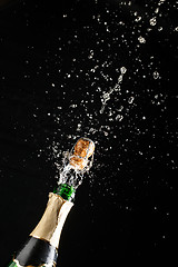 Image showing Classic champagne bottle with cork exploding, alcoholic beverage