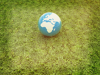 Image showing earth on a green grass. 3D illustration. Vintage style.