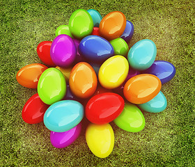 Image showing Colored Easter eggs on a green grass. 3D illustration. Vintage s