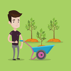 Image showing Man pushing wheelbarrow with plant.