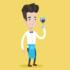 Image showing Bartender holding a glass of wine in hand.