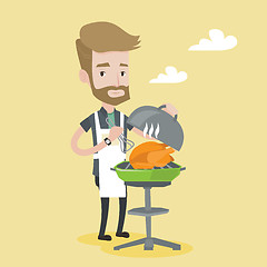 Image showing Man cooking chicken on barbecue grill.