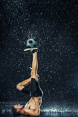 Image showing Water drops around football player