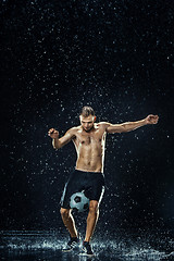 Image showing Water drops around football player