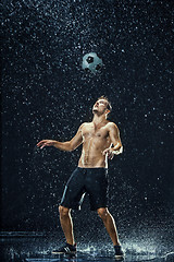 Image showing Water drops around football player