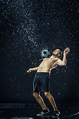 Image showing Water drops around football player