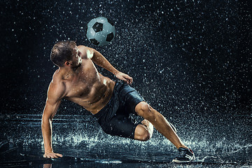 Image showing Water drops around football player