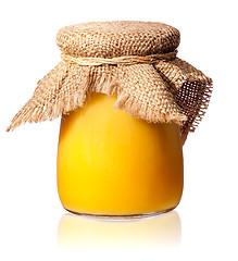 Image showing Honey in a glass jar covered with burlap