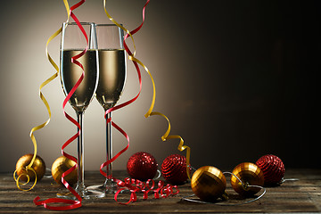 Image showing Two glasses with champagne and Christmas decoration ball