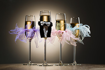 Image showing Decorated glasses of champagne in gentleman costume and female tulle