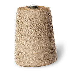 Image showing Vertical bobbin of old dirty thread beige