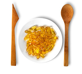 Image showing Fish oil on plate with wooden knife and spoon