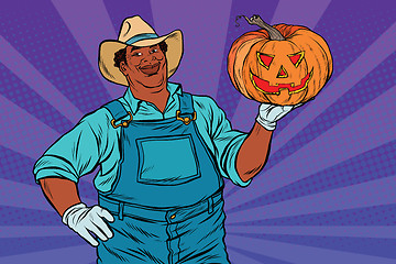 Image showing African American farmer with a Halloween pumpkin