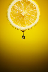 Image showing Drop of fresh lemon juice falling down.