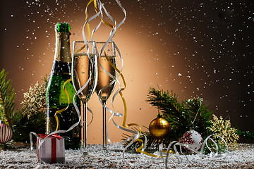 Image showing Champagne, fir-tree branches with toys and gift box