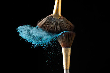 Image showing Beautiful splash after touch of two brushes.