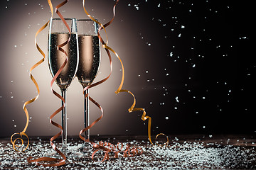 Image showing Romantic image of two glasses with sparkling champagne and ribbons