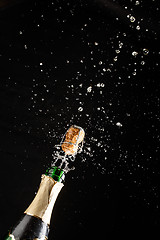 Image showing Closeup of champagne explosion. Vertical image on black background