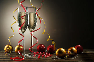 Image showing Two glasses of champagne with bubbles and decorative Christmas balls