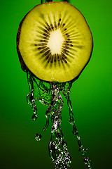 Image showing Ripe kiwifruit with water splash close up