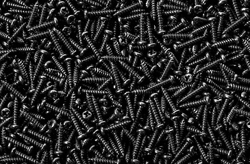 Image showing Background pile of shiny black screws