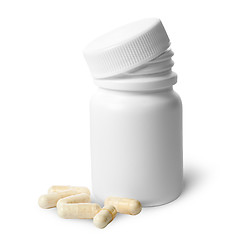 Image showing Beige capsule near the plastic bottle