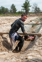 Image showing Men creep on an entrenchment with sand and water