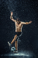 Image showing Water drops around football player