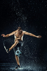 Image showing Water drops around football player