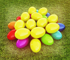 Image showing Colored Easter eggs on a green grass. 3D illustration. Vintage s