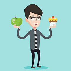 Image showing Man choosing between apple and cupcake.