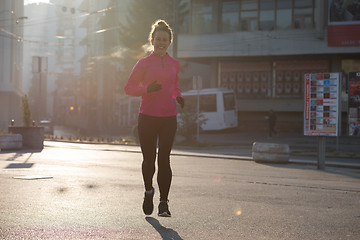 Image showing sporty woman jogging on morning