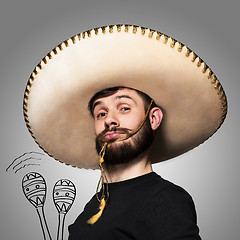 Image showing portrait of funny man in Mexican sombrero on gray background