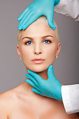 Image showing Cosmetic plastic surgeon touching aesthetics face