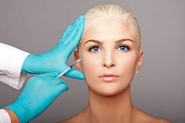 Image showing Cosmetic plastic surgeon injecting aesthetics face