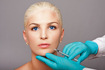 Image showing Cosmetic plastic surgeon injecting aesthetics face
