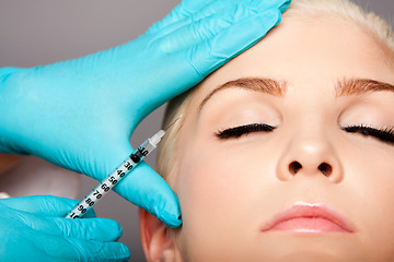 Image showing Cosmetic plastic surgeon injecting aesthetics face