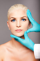 Image showing Cosmetic plastic surgeon touching aesthetics face