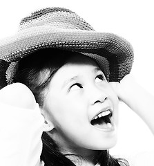 Image showing Smiling And Happy Girl Putting On A Hat