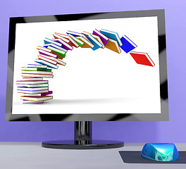 Image showing Stack Of Books Falling On Computer Shows Online Learning