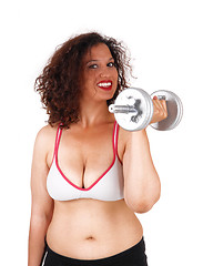 Image showing Busty woman with dumbbells.